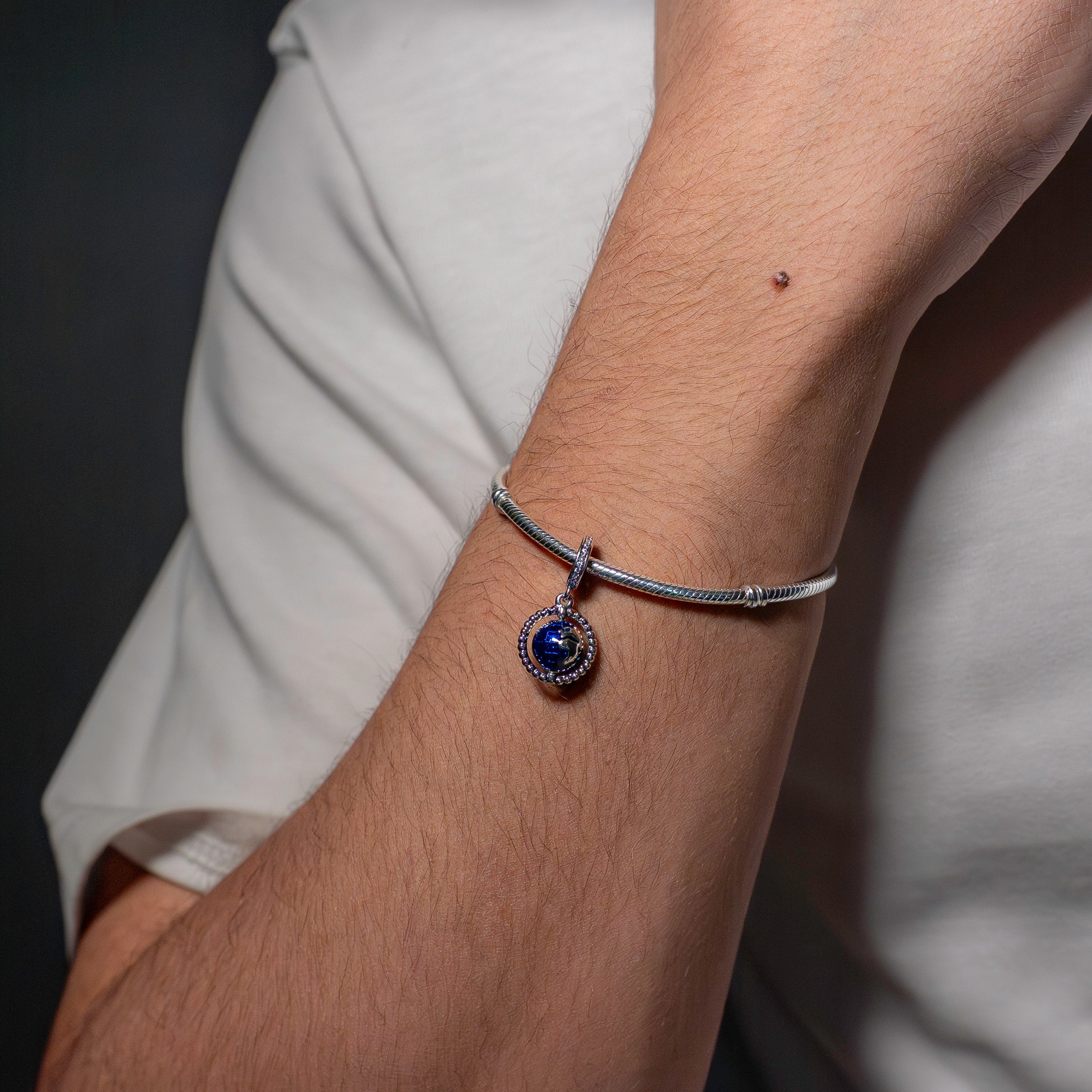 Globe silver dangle with clear cubic zirconia and blue enamel